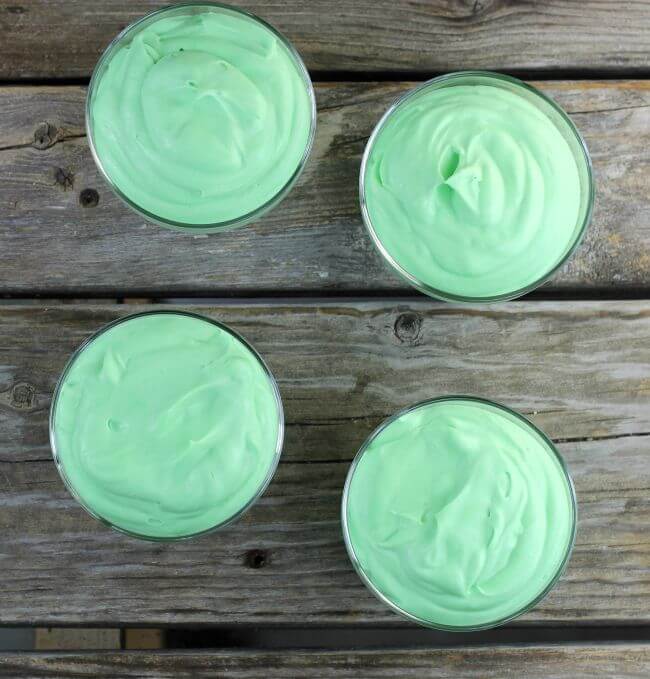 Green pudding in four bowls.