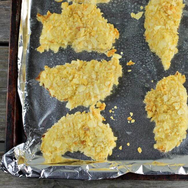 Baked chicken tenders on the baking pan.
