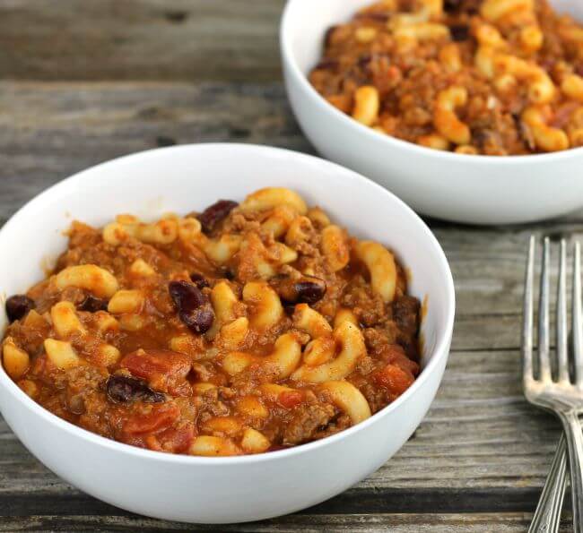 Side angle view of two bowls of chili mac.