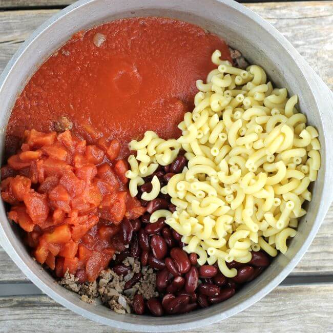 Tomato sauce, tomatoes, beans, and macaroni added to the ground beef.