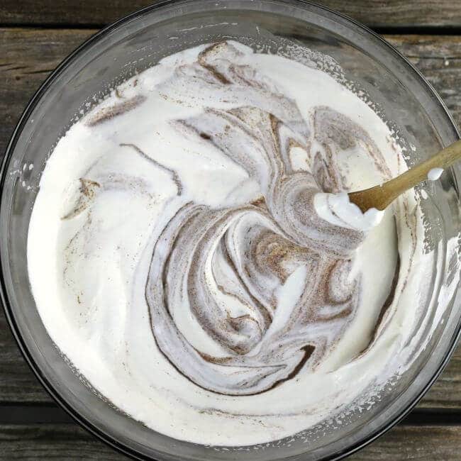 Folding whip cream into the chocolate mixture.