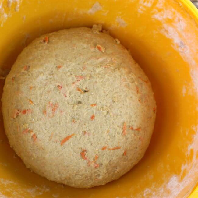 Bread dough in an orange bowl