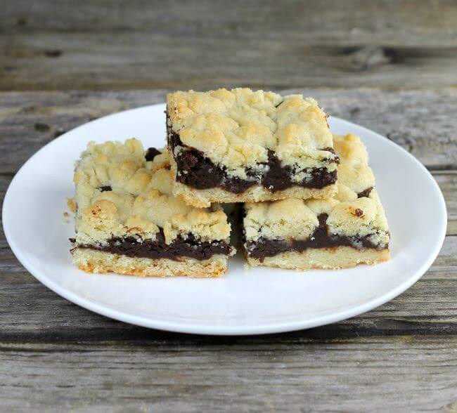 Angle view of three chocolate bars on a plate.