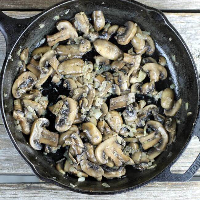 Sauteed mushrooms in a cast-iron skillet.