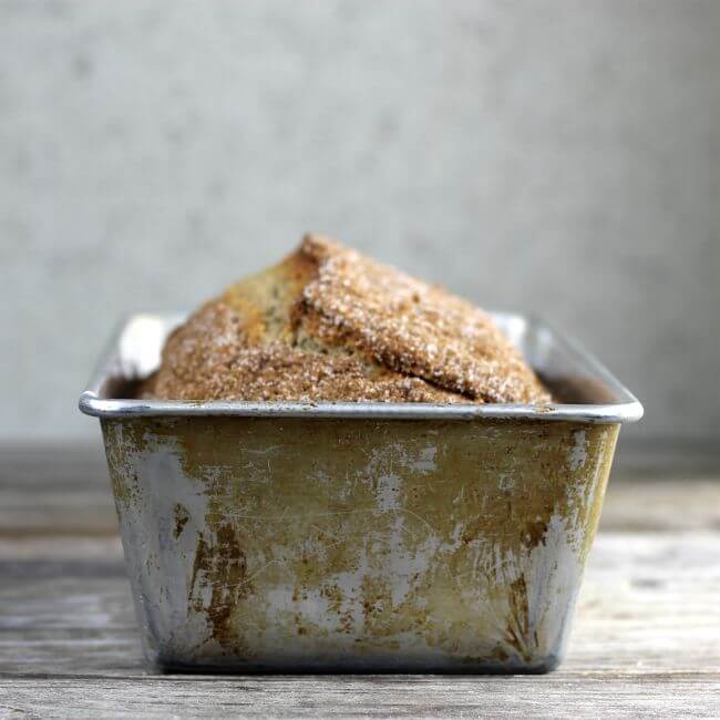 Side view of bread in a bread pan.