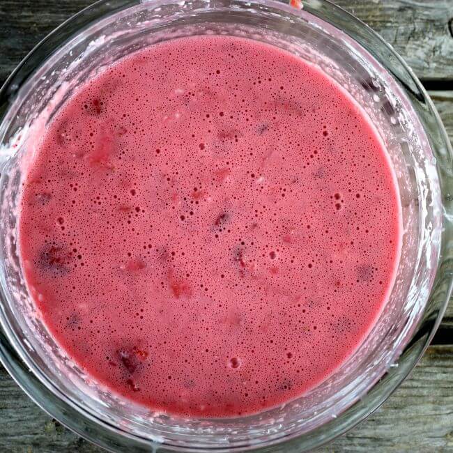 Jello is added to the cream cheese and strawberries.