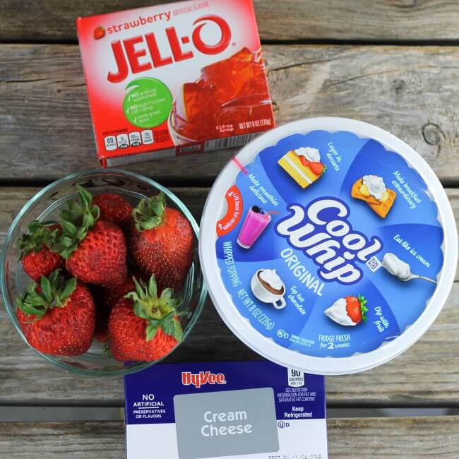 Cool whip, cream cheese, box of Jell-O, and strawberries.