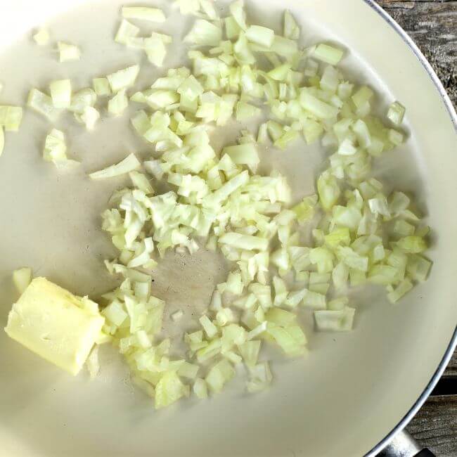 Butter and chopped onions added to a large skillet.