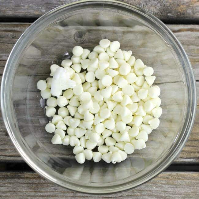 White chocolate chips in a glass bowl.