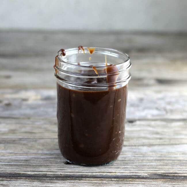 A jar filled with hot fudge.