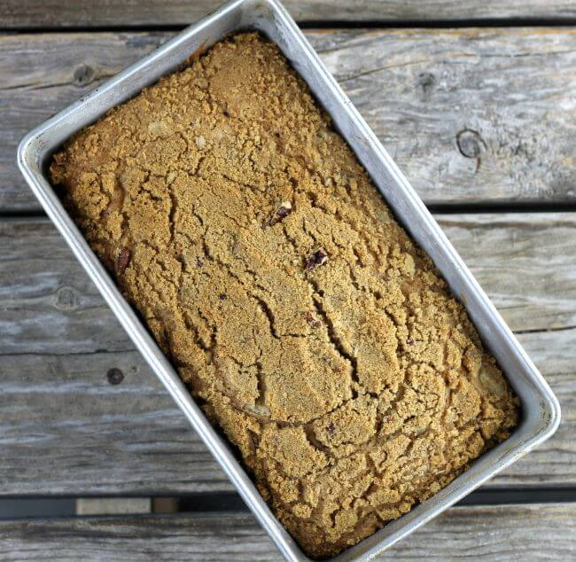 Over looking a bread pan with a loaf of quick bread.