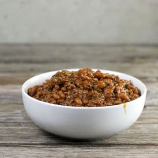 Side view of baked beans in a white bowl.