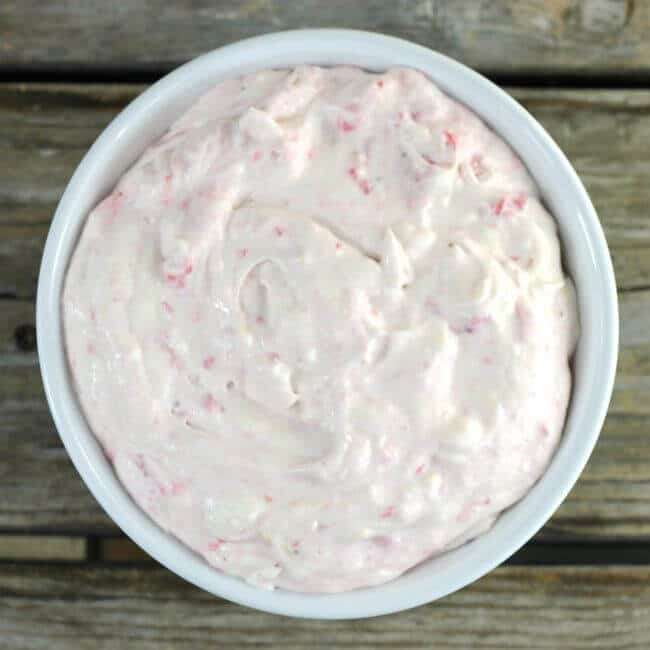 Looking down at a bowl of strawberry cheesecake dip.
