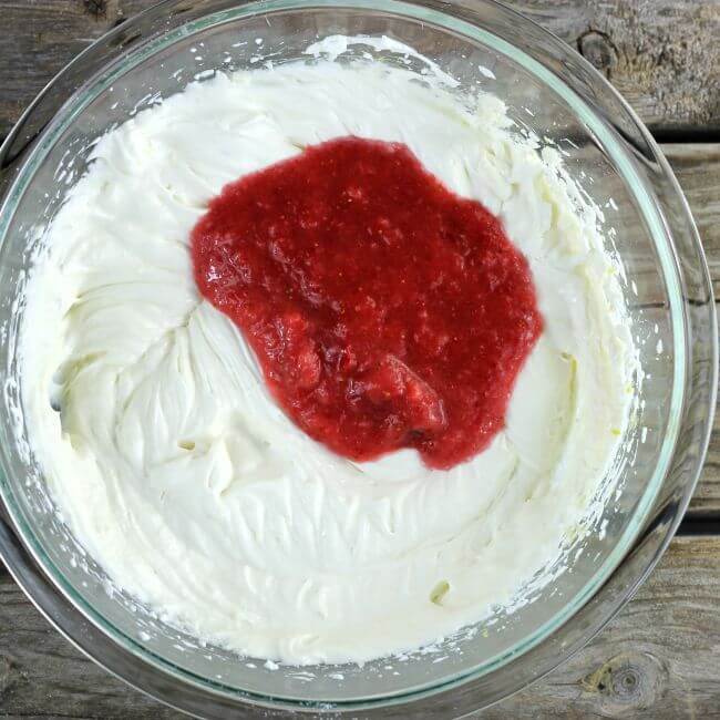 Mashed berries are added to the dip.