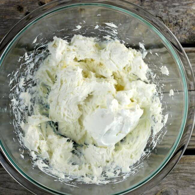 Sour cream add to the cream cheese in a bowl.