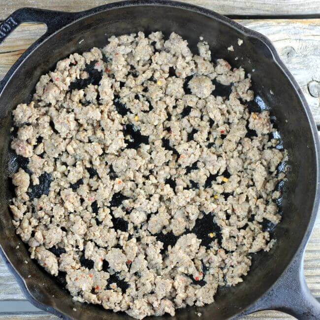 Browned pork sausage in a skillet.