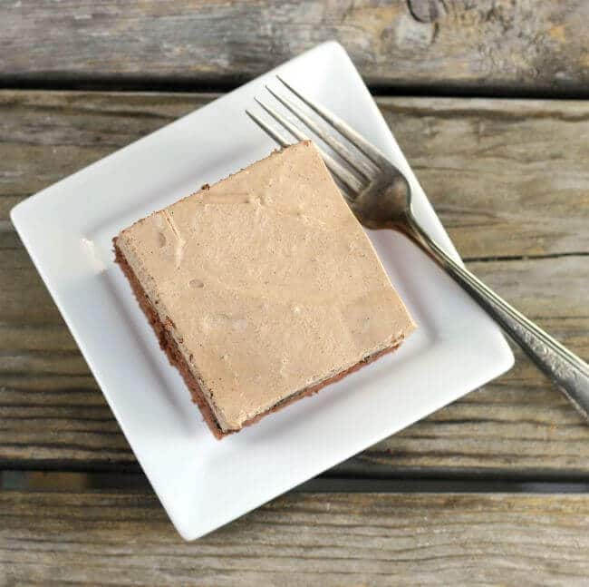 Looking down at a piece of chcolate cake on a white plate.