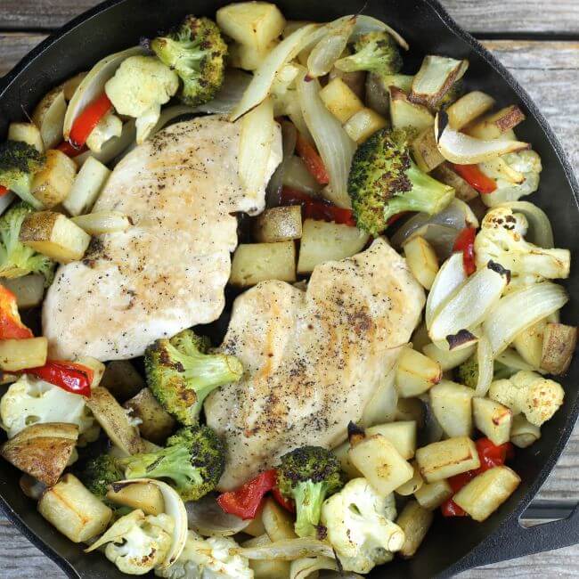 Roasted chicken and vegetables in a skillet.