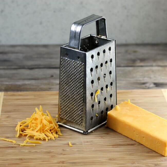 Shredding cheese with a box grater.