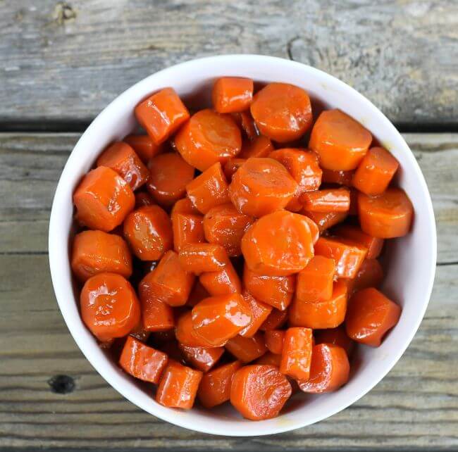 Looking down at a bowl of glazed carrrots.