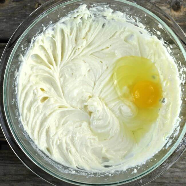 Add an egg to the cream cheese.