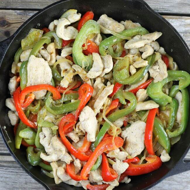 Chicken and vegetables in a skillet.