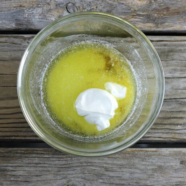 Melted butter, sour cream, and vanilla in a glass bowl.