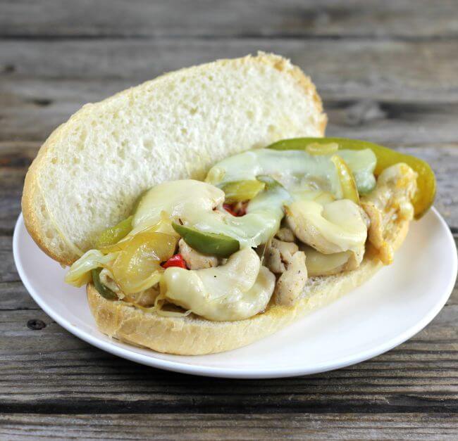 Side view of an open chicken philly sandwich.