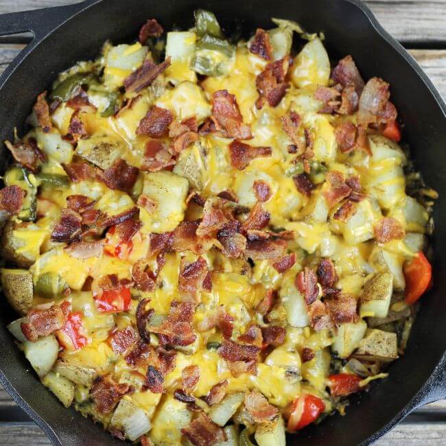 A loaded potato skillet potatoes, peppers, bacon, and cheddar cheese.