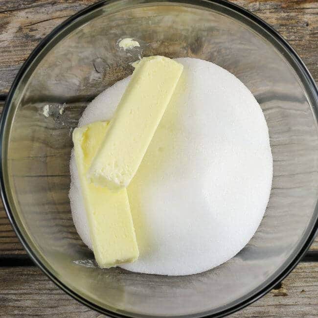 Sugar and butter are added to a large mixing bowl.