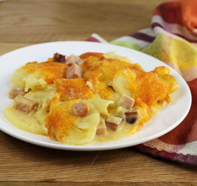Side angle view of a plate of scalloped potatoes