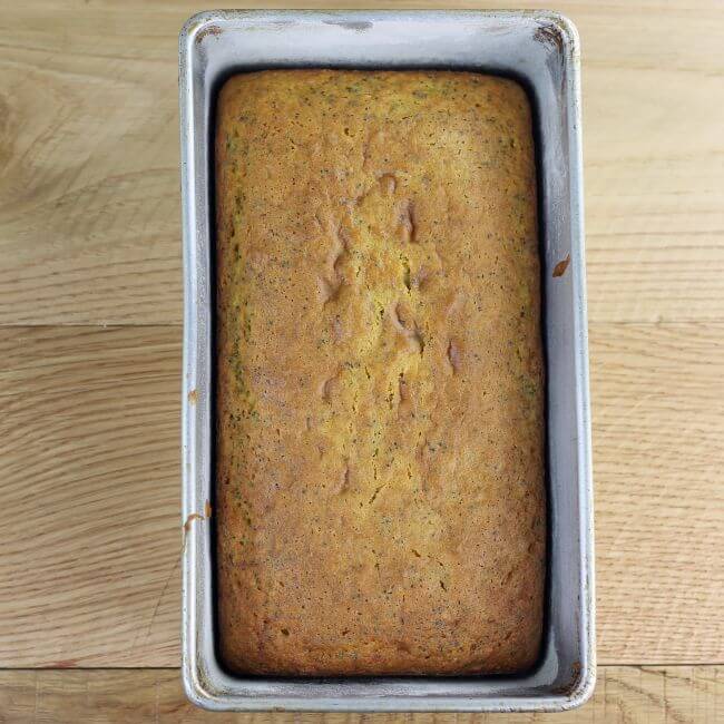 Baked lemon bread in a loaf pan.