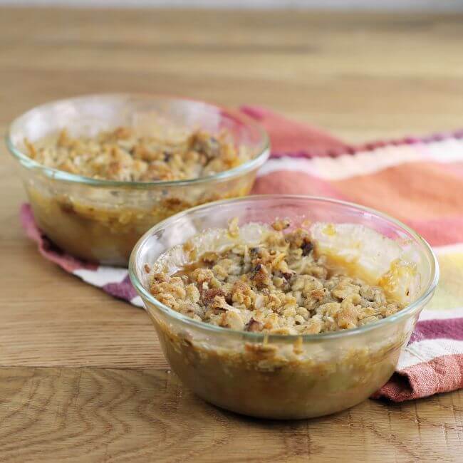 A side view of rhubarb crisp in custard cups/