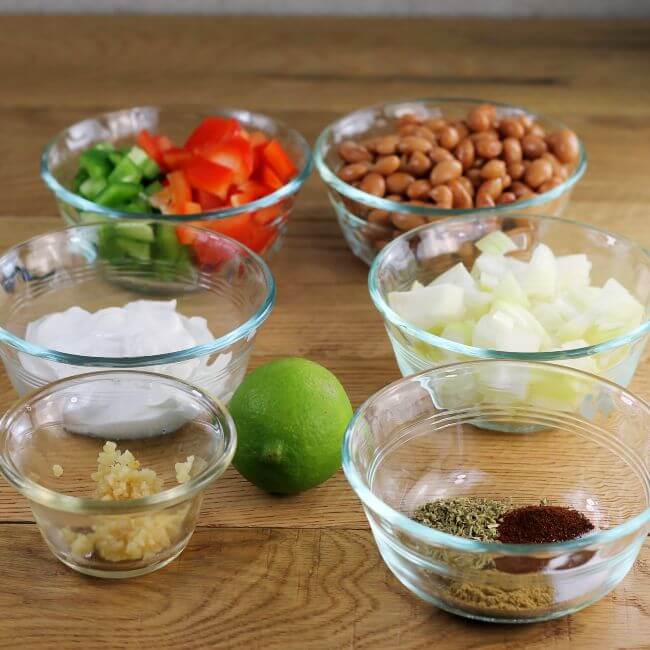 Ingredients for bean dip in small bowls.