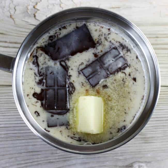 Butter, chocolate, milk, and sugar in a saucepan.