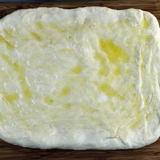 Dough with olive oil spread on top.