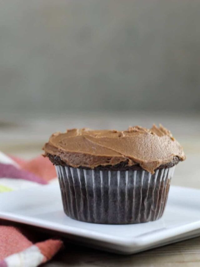 Cream Cheese filled chocolate cupcake on a white plate.