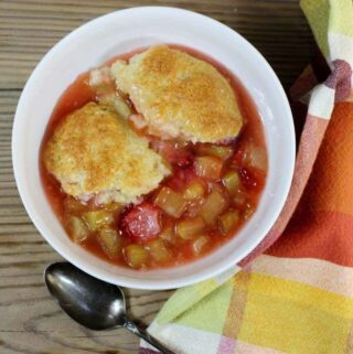 Looking down at a bowl of strawberry rhubarb cobbler.