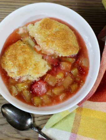 Looking down at a bowl of strawberry rhubarb cobbler.