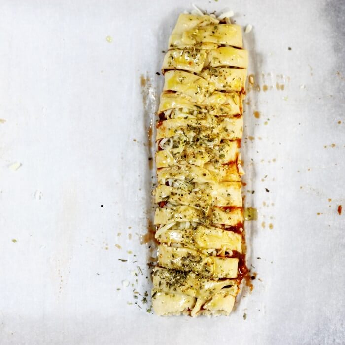 The crescent braid is brushed with olive oil and sprinkled with Italian seasoning.