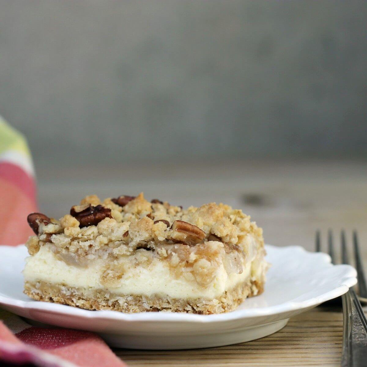 A pear bar on a wihite plate with a fork on the side.